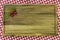 Five cherries with leaves in corner of wooden board