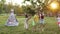 Five Children In The Garden Playing Blindfold. Children In The Images Of Indians. One Boy Is Blindfolded. He Catches