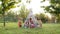 Five Children Play Indians. Three Boys And Two Girls Are Sitting In Tent Outdoors With Painted Faces And Arrows In Their