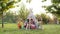 Five Children Play Indians. Three Boys And Two Girls Are Sitting In Tent Outdoors With Painted Faces And Arrows In Their