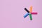 Five colorful pen cap on a pink millennial background. Space to insert the text. Office stuff. Minimalism.