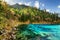 The Five Coloured Pool with azure water among wooded mountains