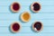 Five colourful jam tarts on a blue background