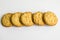 Five crispy with zest cookies on a white background