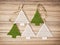 Five crochet christmas trees on the wooden background