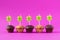 Five Cupcakes with candles over a pink background.
