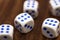 Five dice on a wooden desk. Five dice shows the six, what a luck