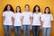 Five Diverse Girls Posing Standing Over Yellow Studio Background