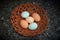 Five eggs in a basket on granite background