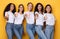 Five Females Models Gesturing Thumbs-Up Approving Something Over Yellow Background