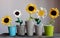 Five flower vase on table, knit white and yellow sunflower from yarn