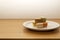 Five french macarons in plate on wooden table