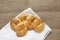 Five freshly baked gluten free rings on a white kitchen towel. Composition in a rustic style. Curd bagels on a rough textured