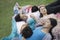 Five friends sleeping and resting on each other during a picnic in the park