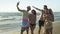 Five friends taking a selfie on sandy beach