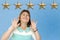 Five gold foil star on blue background, female client is unhappy, concept of evaluating the result, rating, Satisfaction