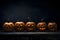 Five gouged jack-o-lantern pumpkins on a dark background, a Halloween image