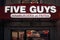 Five Guys logo on their main fast food restaurant for Montreal, Quebec, iwith their slogan in French