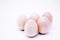 Five hand-made unpainted wooden eggs on a white background