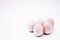 Five hand-made unpainted wooden eggs on a white background. Copy space