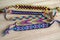 Five handmade homemade colorful natural woven bracelets of friendship on wooden board, group of fashion accessories
