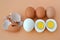 Five hard boiled brown chicken eggs on a brown background