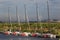 Five J/70 yachts moored in the wake against the backdrop of the shore on a sunny summer evening