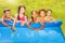 Five kids friends portrait on swimming pool border