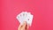 Five of a kind Poker Game cards in gambler hand pink background. Lucky combination Aces and Joker revealing. Online gambling 4K