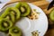 Five kiwi fruit slices on a white table