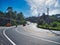 Five-lane highway with different vehicles under the blue sky and white clouds