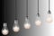 Five lightbulbs with lit stars on black and white background. ranking or rating image concept