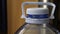 Five liter bottle - close up. Plastic container with water. Blue plastic bottle stopper