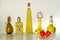 Five little bottles of Italian extra virgin olive oil on light background