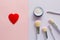 Five makeup brushes with lettering on the handle and mineral powder in a blue jar, red felt brooch in the form of a heart