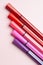 Five markers or pens of pink, purple, pink color lie like steps on a pink background, isolated mock up