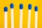 Five matchsticks on yellow background