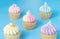 Five mini cupcake on blue pastel