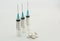 Five ml disposable plastic syringes blue needles white pills