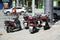 Five motorbikes parked on side of street in city