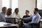 Five multiethnic businesspeople shake hands start or accomplish formal meeting