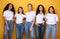 Five Multiethnic Models Girls Smiling Standing In Studio, Yellow Background