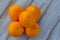 Five oranges on a wooden table