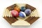 Five painted eggs on a wooden plate