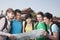 Five people looking at map with Tiananmen Square in background.