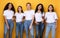 Five Positive Multiethnic Women Posing Standing Together, Yellow Background