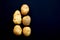 Five potato heads on dark background