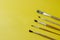 Five random brushes for painting on yellow background