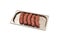 Five raw sausages for barbecue grill on metal tray. Natural meat processed foods. Frankfurters. White background. Selective focus