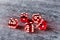 Five red glass dices on gray background